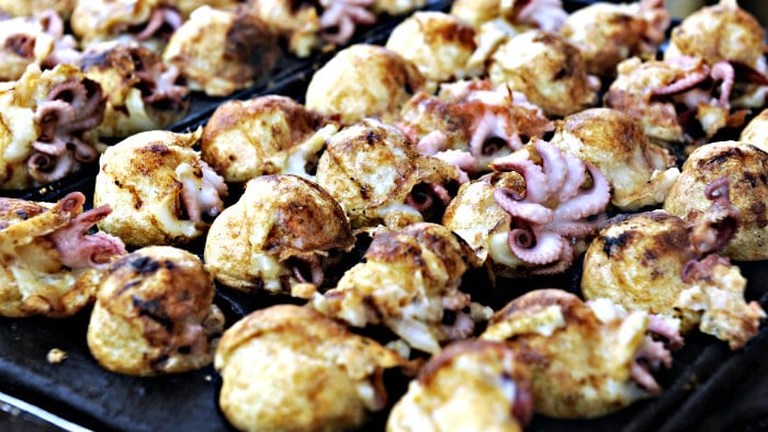 Takoyaki are made with pieces of octopus.