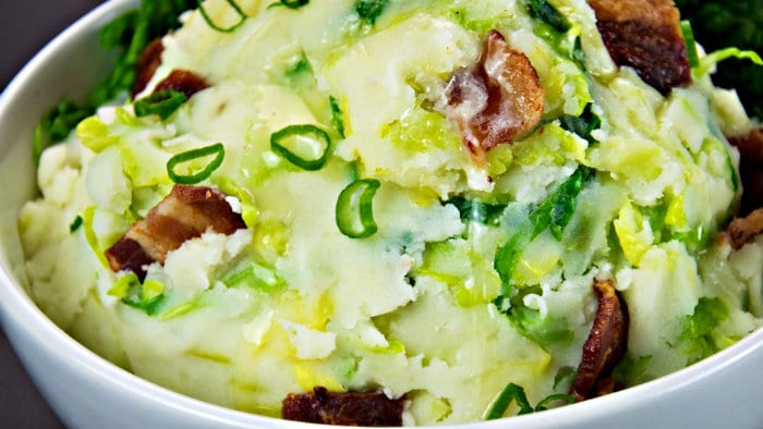 To make colcannon, add cooked kale or cabbage to mashed potatoes.