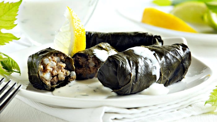 Dolmades are made with ground meat stuffed in grape leaves.