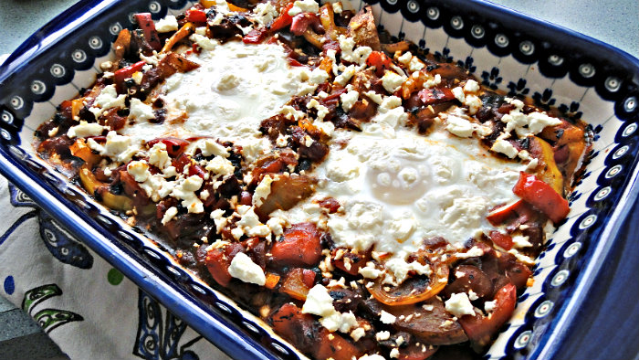 Shakshuka is made with onions, garlic, tomatoes, peppers, and eggs.