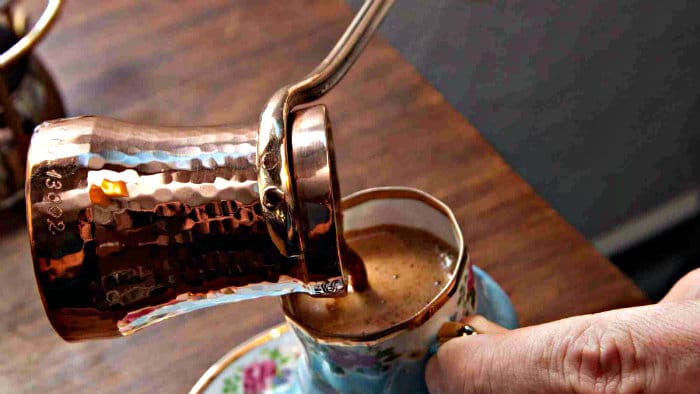 Turkish coffee is made in a small copper pot with a long handle.