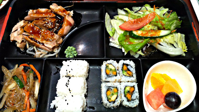 Japanese passengers buy Bento boxes before boarding the bullet train.