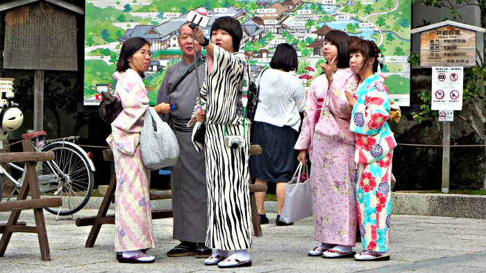 Taking a selfie in traditional Japanese costumes.